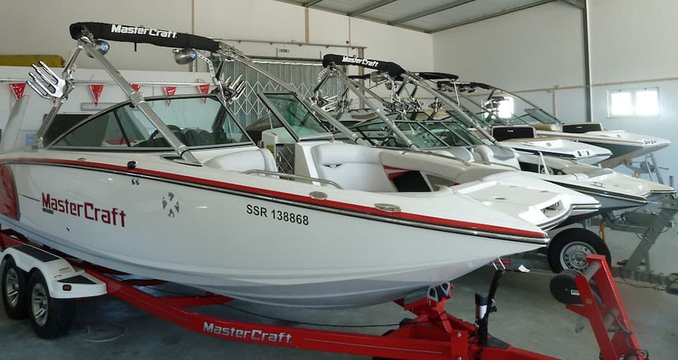 Boats stored on trailers inside Algarve Boat Sales' indoor storage facility